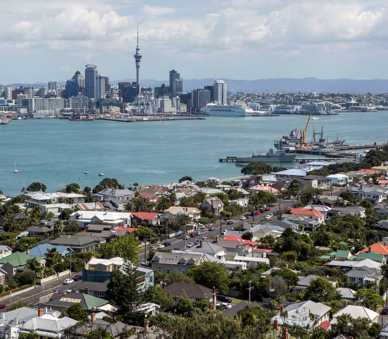 Auckland cityscape with Sky Tower and Waitematā Harbour.