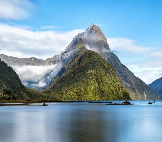 Milford Sound's fjord view with towering mountains and calm waters.