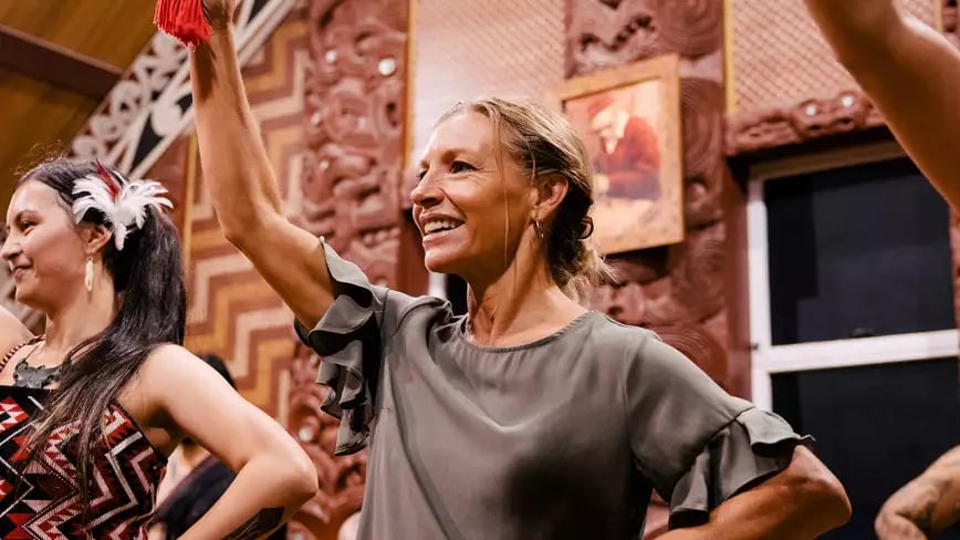 Maori dancers performing with traditional attire in New Zealand.