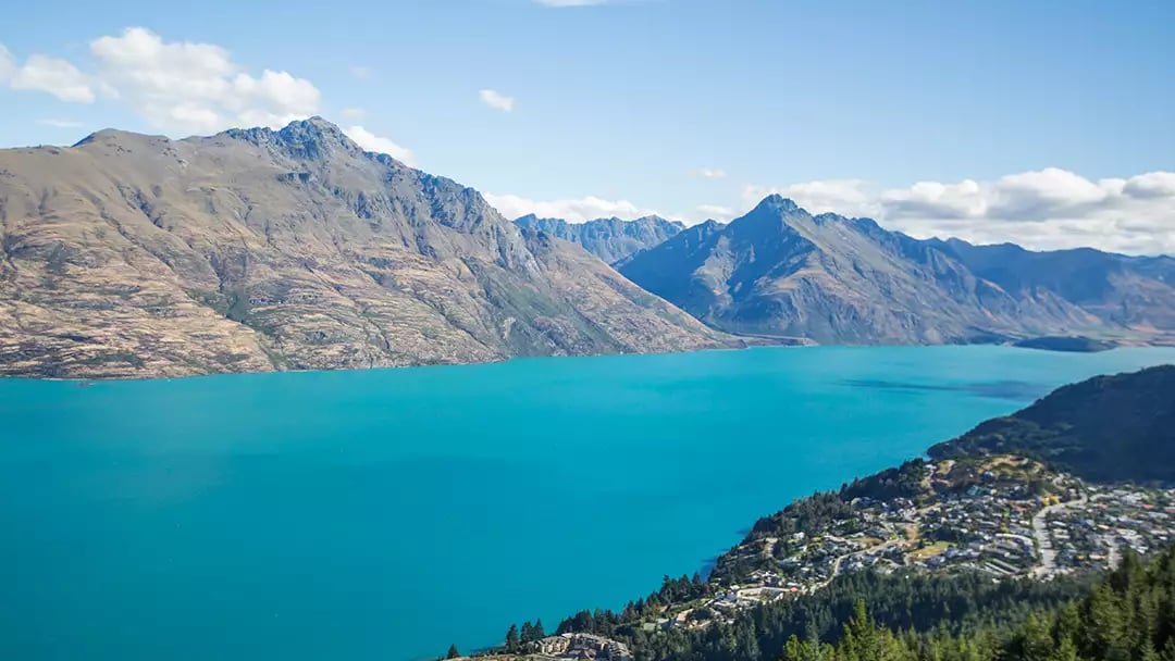 Scenic view of Lake Wakatipu and surrounding mountains in Queenstown, New Zealand.