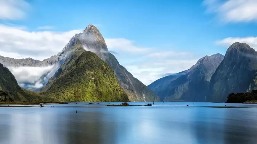 Milford Sound's fjord view with towering mountains and calm waters.