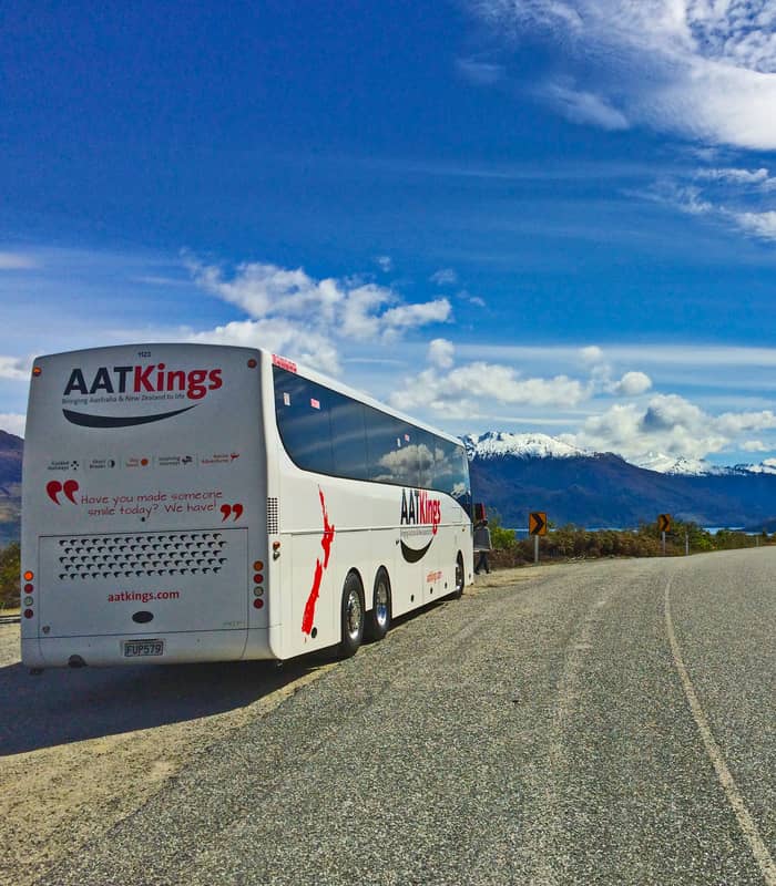 AAT Kings coach on road with mountains in new zealand south island