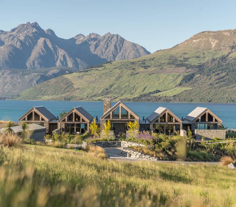 View of the Blanket Bay accommodation with lake and mountains in the background