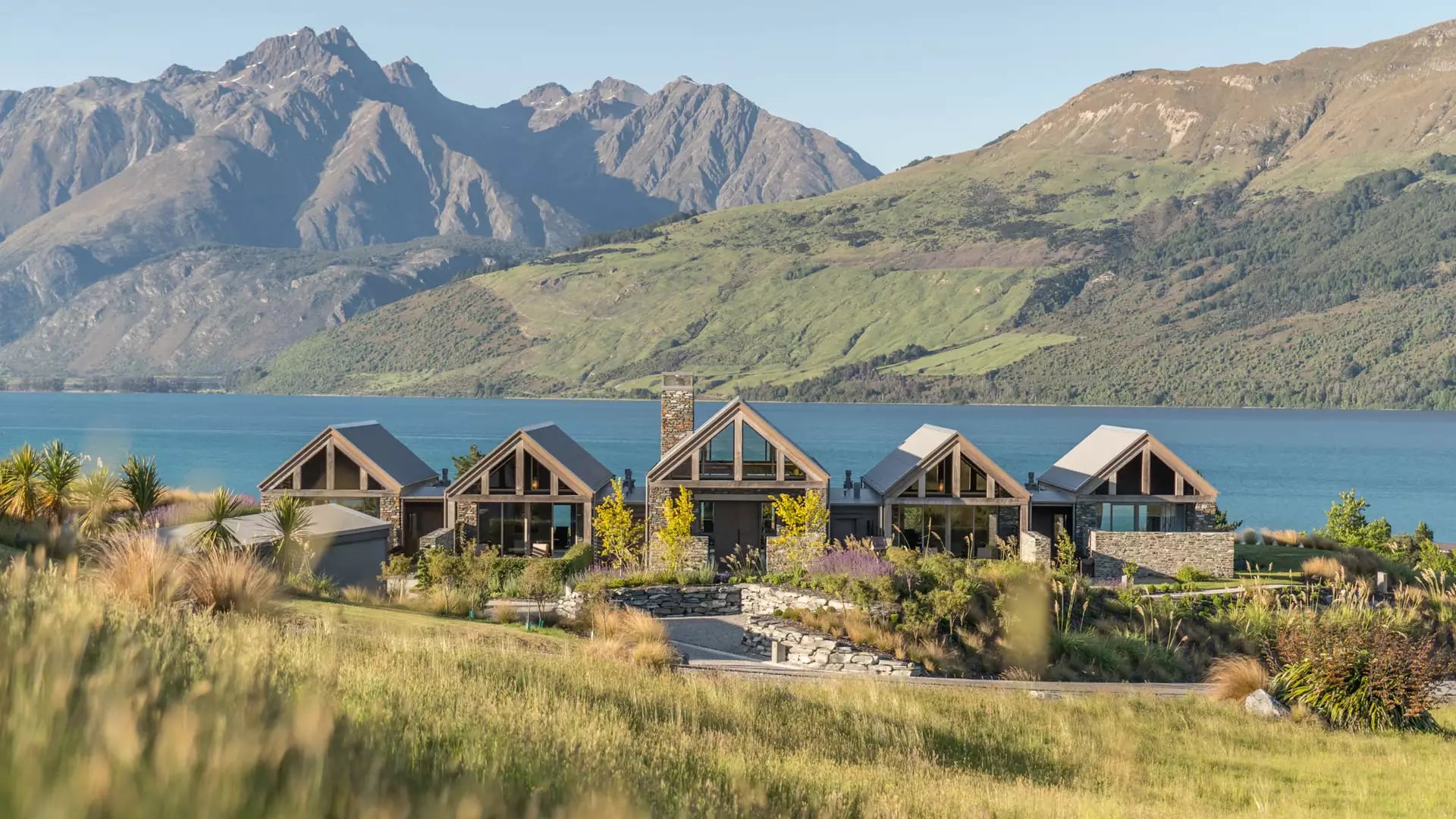 View of the Blanket Bay accommodation with lake and mountains in the background