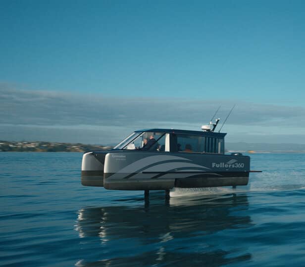 Side view of a Fullers360 hydrofoiling boat above the blue ocean water.