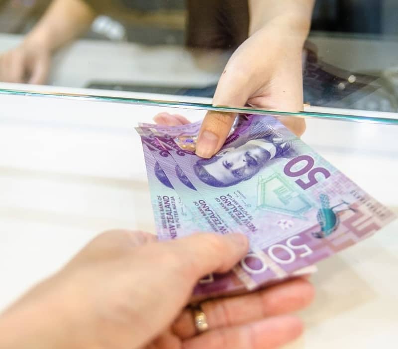 Photo of New Zealand money being handed over