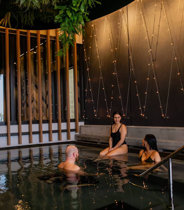 People relaxing in pool talking at Wai Ariki