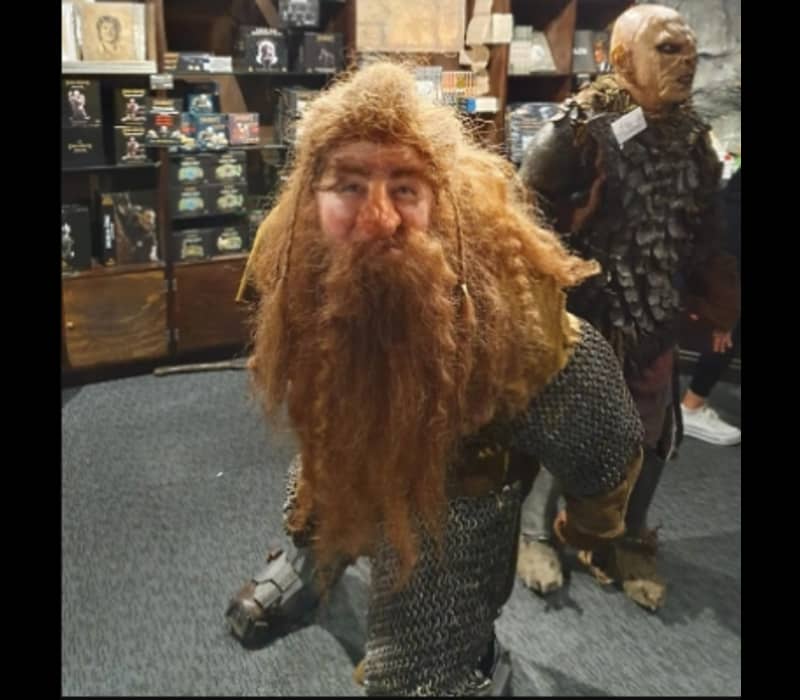 Medieval figure with red beard and chainmail in a museum exhibit.
